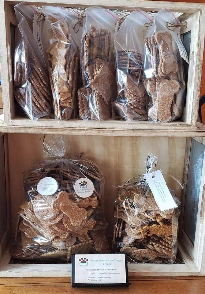 A market display filled with bags of Patty's homemade dog treats