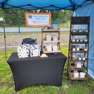 Patty's Pawsitively Perfect Dog Treats stand at a local outdoor market